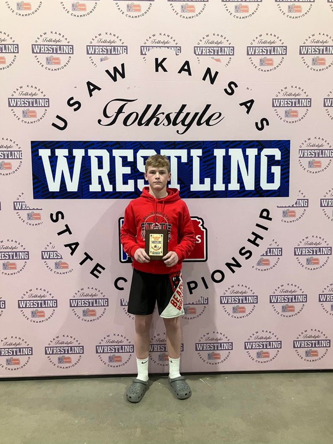 Ellsworth wrestler holding a state wrestling award